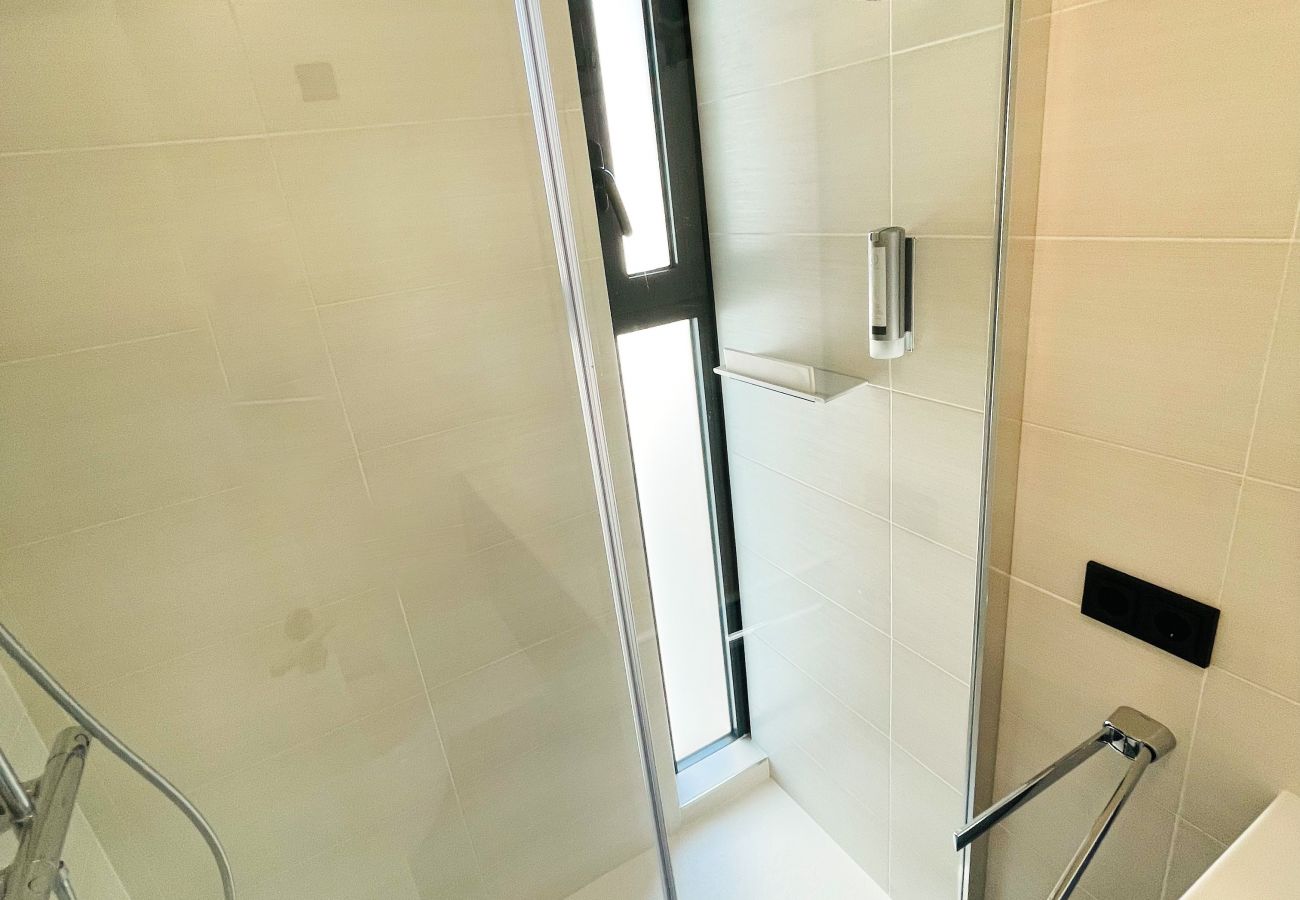 The bathroom contains a large modern shower.