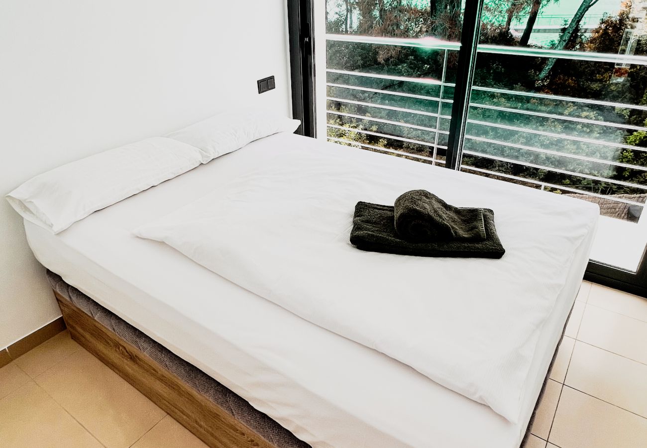 The beautifully furnished bedroom is cozy and modern. It also includes a large balcony with a unique view.