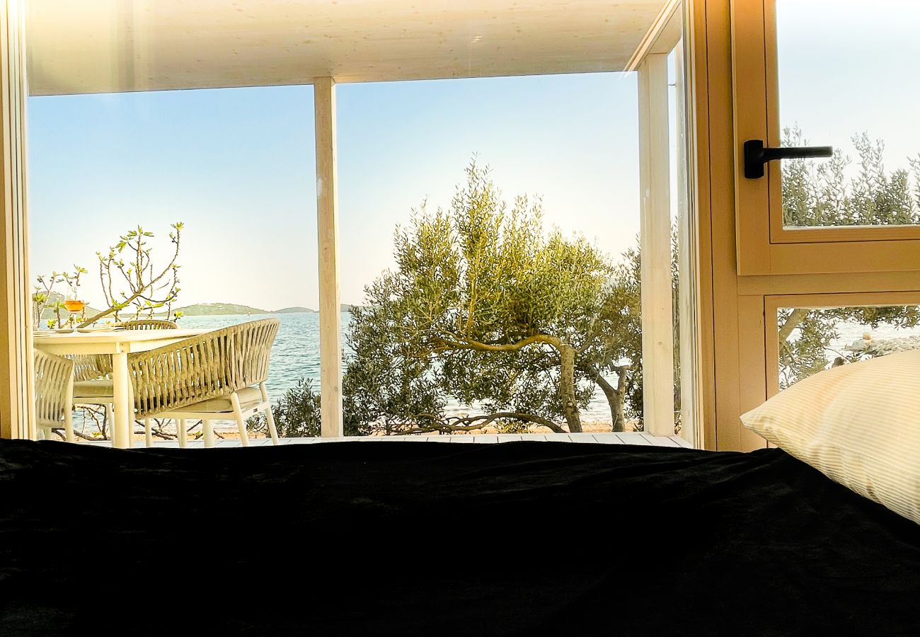 The modern and cozy bedroom has an incredible view of the sea.