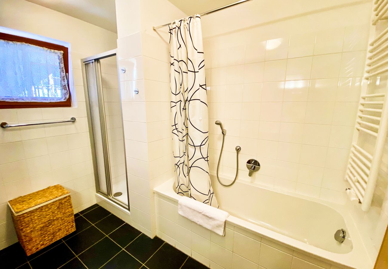 In the large bathroom there is both shower and bathtub.