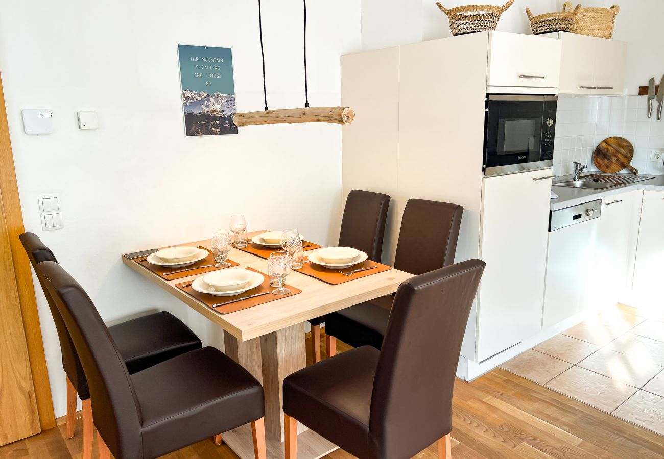 Next to the kitchen is the table, which, like the rest of the apartment, is furnished in the beautiful Bavarian Alpine style.