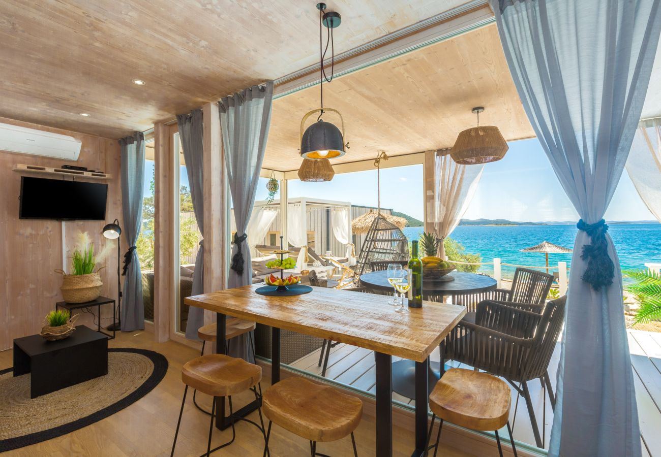 Bright, modern interior with open terrace, sea views, rustic wooden furniture, boho decor and cozy atmosphere.