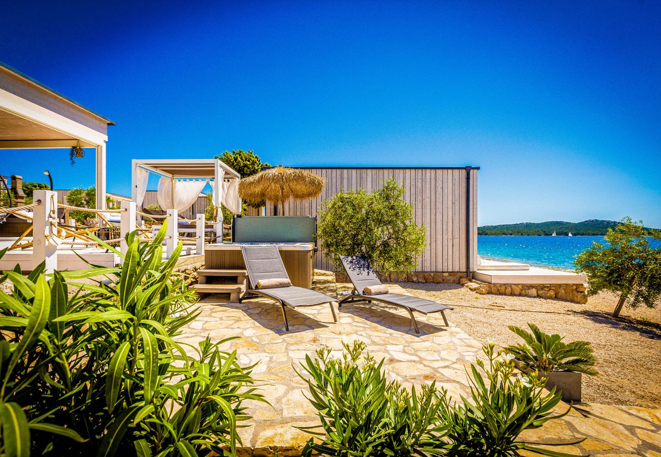 Beach terrace with loungers, plants, jacuzzi and a view of the sea right in front of you