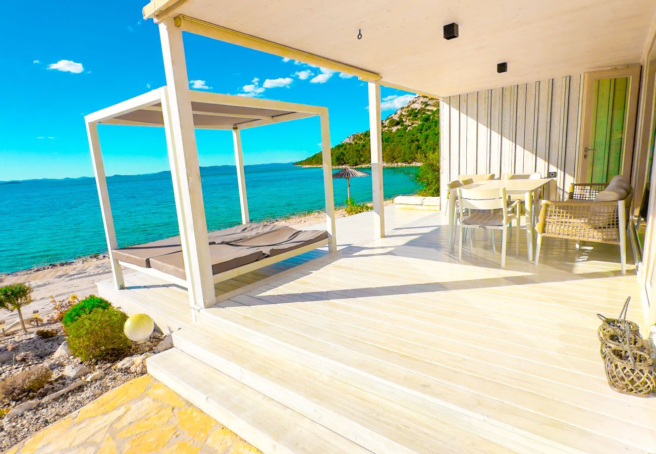 Auf der großen Terrasse vorm Haus kann man sich entspannen und ist zugleich direkt am Strand mit Meerblick.